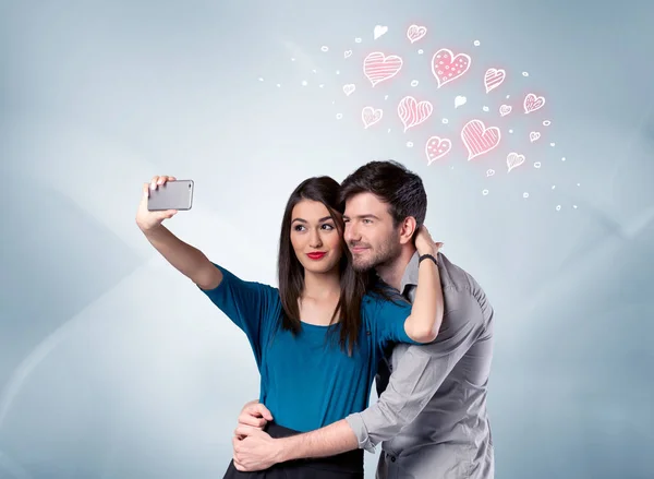 Couple in love taking selfie with red heart — Stock Photo, Image