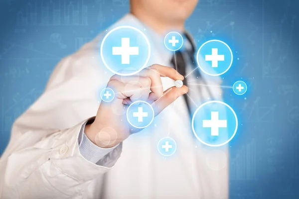 A doctor showing a pill with crosses — Stock Photo, Image