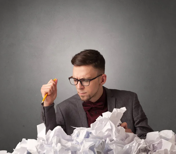 Businessman behind crumpled paper