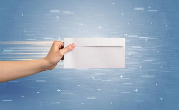 Hand holding envelope with arrows around — Stock Photo, Image