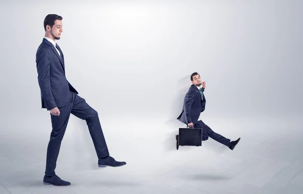 Small man fired by boss with white wallpaper — Stock Photo, Image