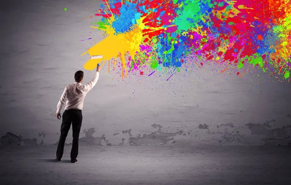 Sales person painting colorful splatter — Stock Photo, Image