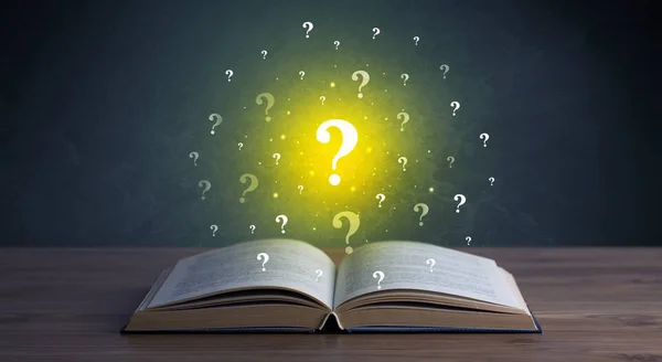 Question marks over book — Stock Photo, Image