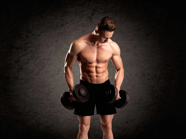 Sexy weight lifter guy showing muscles Stock Photo