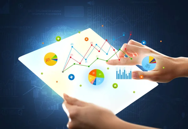 Hände berühren eine glasartige Tablette mit Diagrammen — Stockfoto