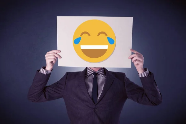 Businessman holding paper with laughing emoticon — Stock Photo, Image