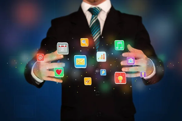 Businessman holding application icons — Stock Photo, Image