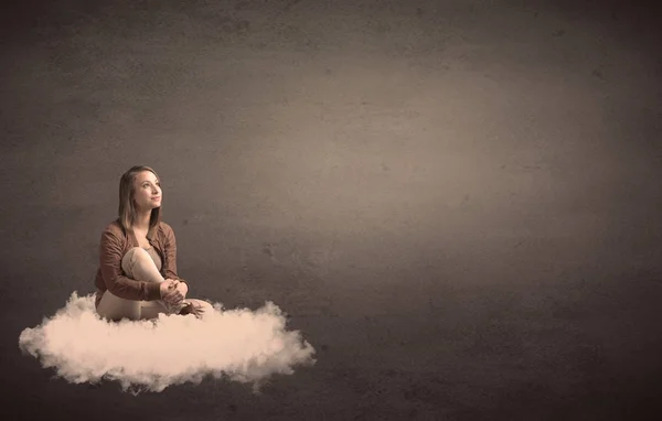 Woman sitting on a cloud with plain bakcground — Stock Photo, Image