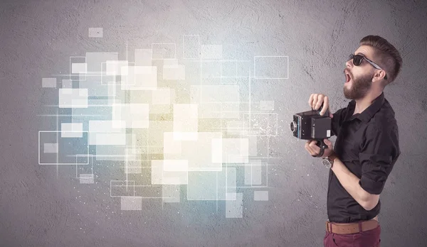 Hipster guy with retro camera in action — Stock Photo, Image