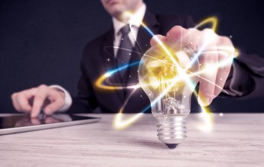 renkli bir ampul tutan işadamı