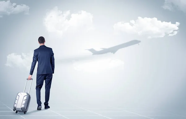 Businessman with luggage  look to an airplane — Stock Photo, Image