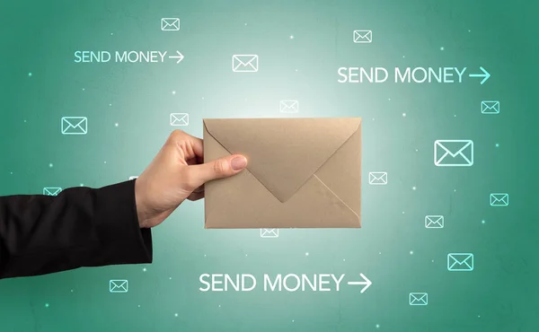 Hand holding envelope with symbols around — Stock Photo, Image