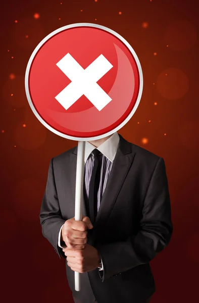 Businessman holding x sign — Stock Photo, Image