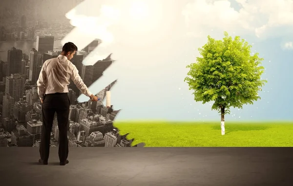 Salesman painting tree instead of city — Stock Photo, Image