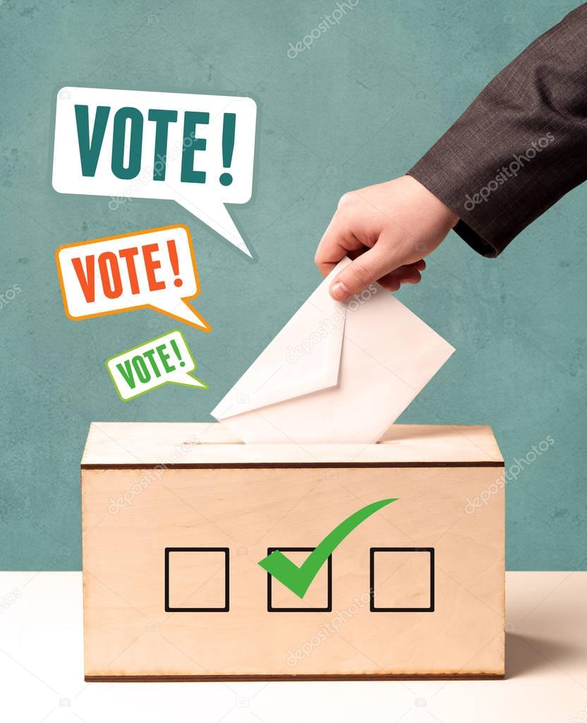 placing a voting slip into a ballot box