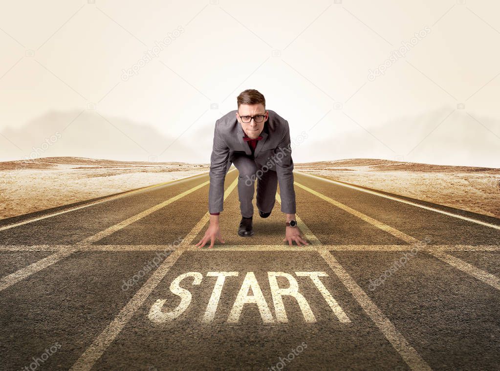 Businessman kneeling in ready position