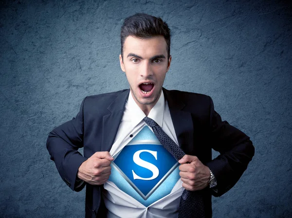 Businessman ripping off his shirt with superhero sign — Stock Photo, Image