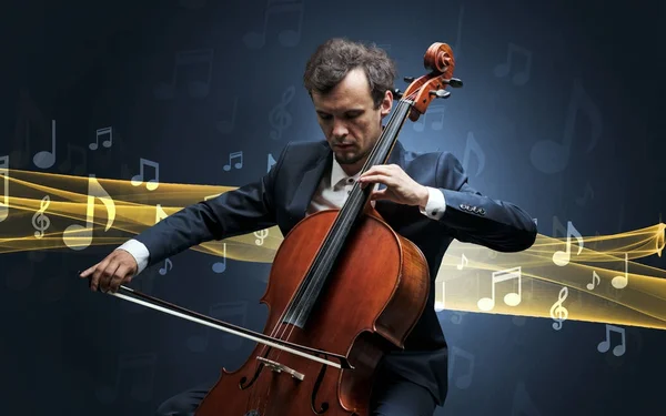 Musicien jouant sur violoncelle avec des notes autour — Photo
