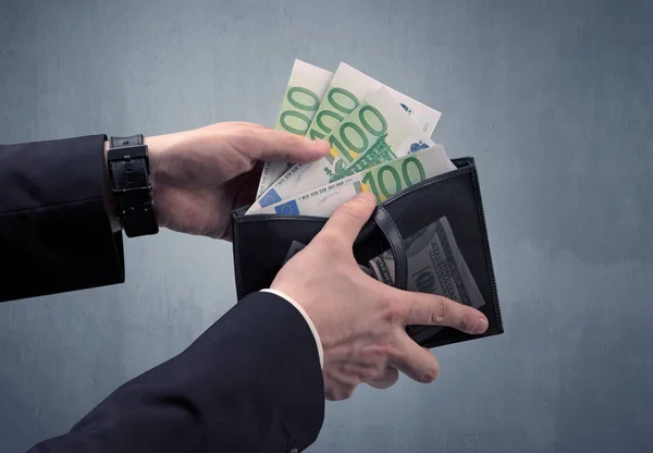 Hand in suit takes out euro from wallet — Stock Photo, Image