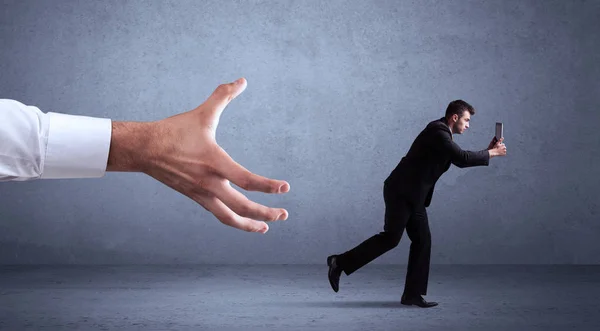 Businessman running from hand — Stock Photo, Image