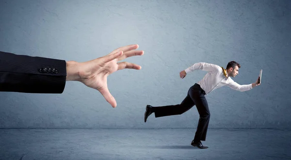 Businessman running from hand — Stock Photo, Image