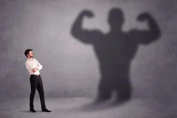 Business man looking at his own strong fit shadow concept — Stock Photo, Image