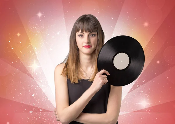 Women holding vinyl record