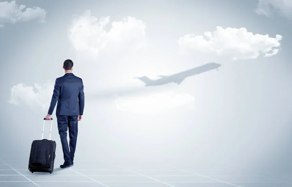 Businessman with luggage  look to an airplane — Stock Photo, Image