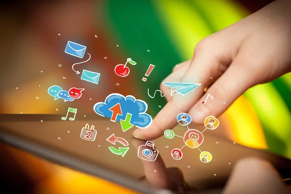 Fingers touching tablet with social icons — Stock Photo, Image