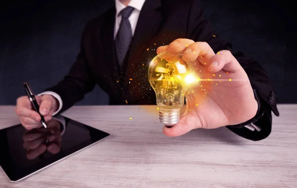 Office worker holding a light bulb — Stock Photo, Image