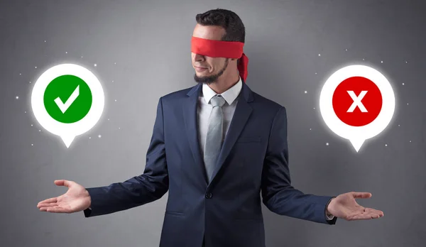 Blindfolded businessman trying to choose — Stock Photo, Image