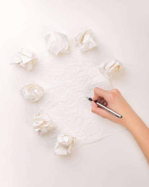 Writing hand in crumpled paper