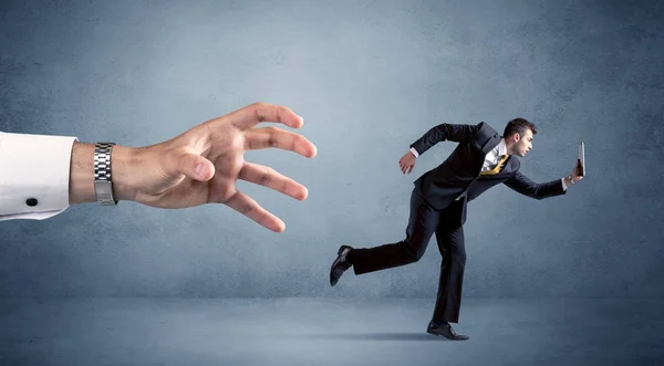 Businessman running from hand — Stock Photo, Image