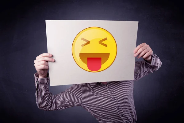 Businessman holding paper with emoticon — Stock Photo, Image