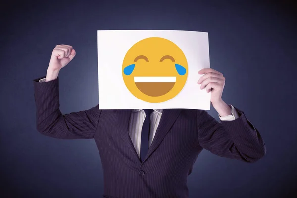 Businessman holding paper with laughing emoticon — Stock Photo, Image