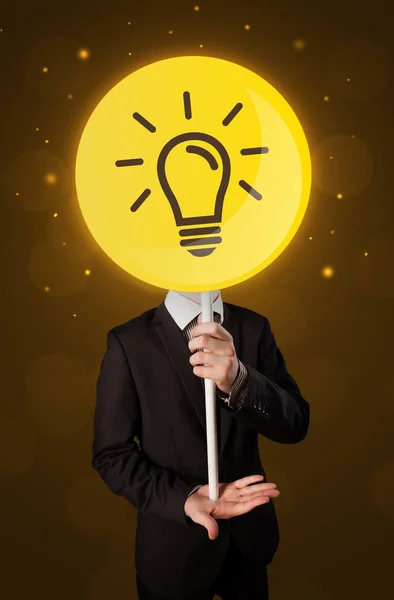 Businessman holding lightbulb sign — Stock Photo, Image