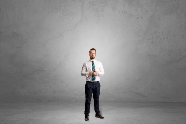 Alone businessman standing in a dark room — Stock Photo, Image