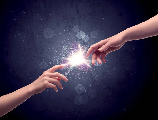 Hands reaching to light a spark — Stock Photo, Image