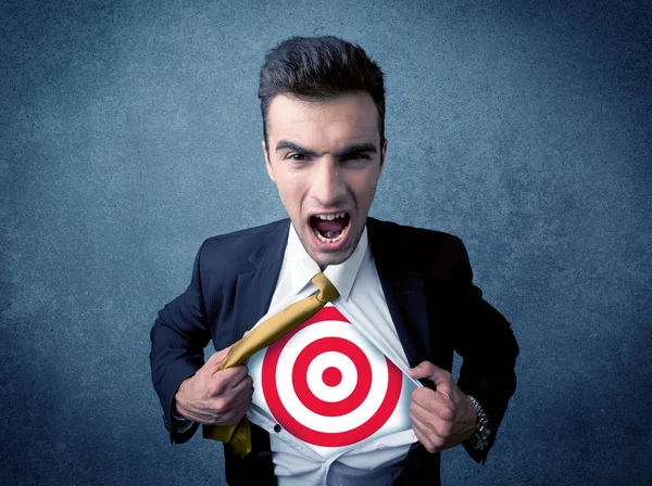 Businessman tearing shirt with target sign on his chest — Stock Photo, Image