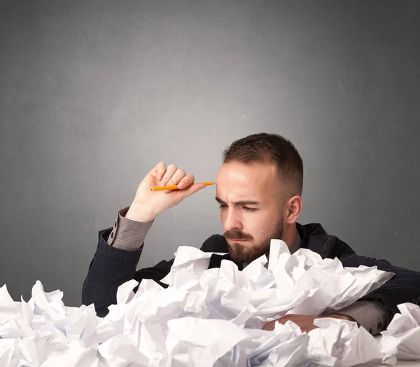 Businessman behind crumpled paper