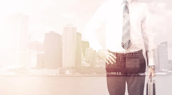 Businessman standing at cityscape background — Stock Photo, Image