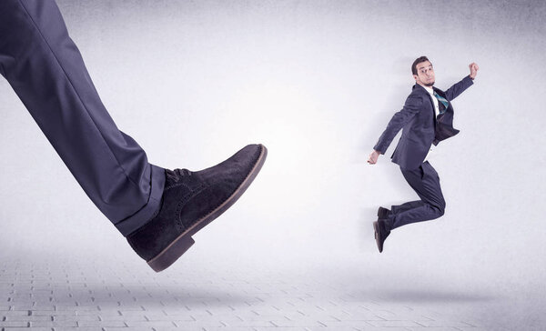 Young worker kicked out by big foot