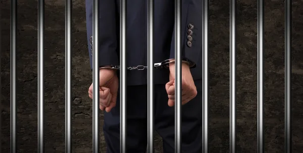 Close handcuffed man in jail — Stock Photo, Image