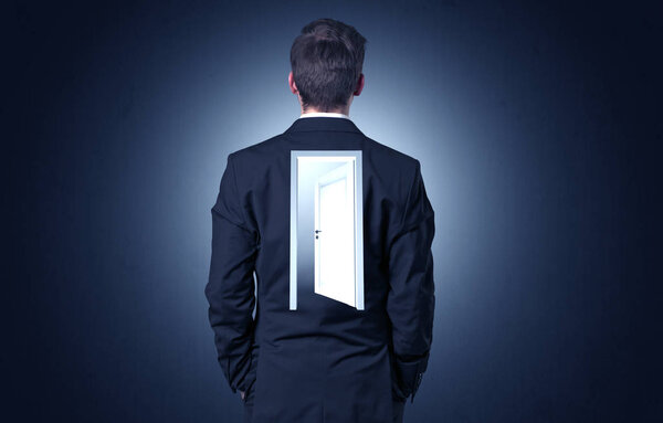 Businessman standing with door on his back