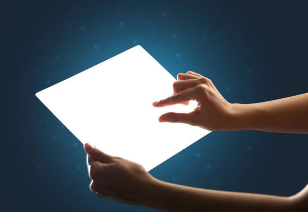 Hands touching a glass-like tablet