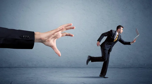 Businessman running from hand — Stock Photo, Image