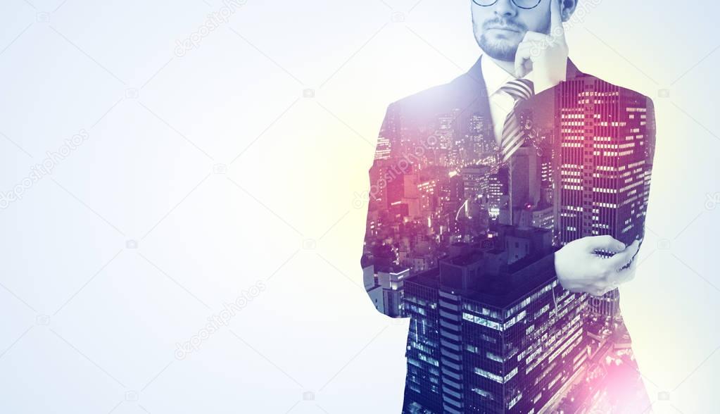 Businessman standing with night city graphic