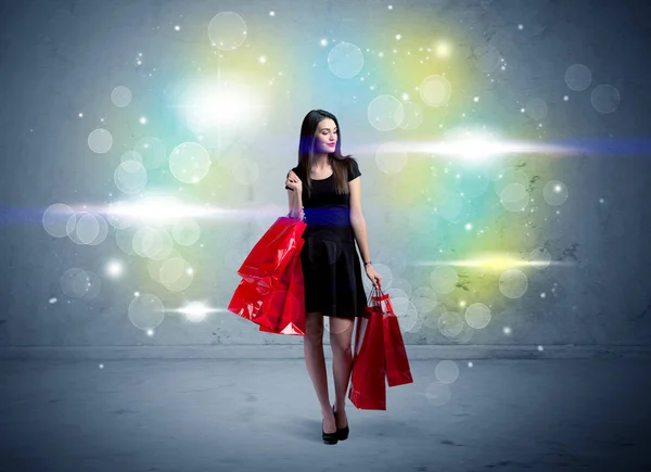 Centro commerciale signora con borse della spesa e luce glitter — Foto Stock