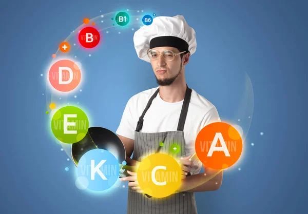 Guapo cocinero con concepto de vitaminas — Foto de Stock