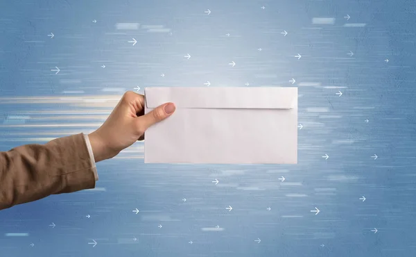 Hand holding envelope with arrows around — Stock Photo, Image